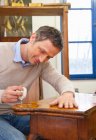 Carpenter buffing wooden table — Stock Photo