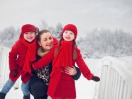 Mother and daughters playing in snow — Stock Photo