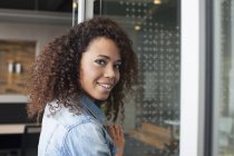 Portrait of young woman at office doorway — Stock Photo