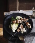 Pork kebab with chicory and creamy dressing — Stock Photo