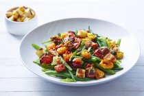 Still life of roast tomatoes and green beans salad — Stock Photo