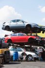 Damaged cars stacked in scrap yard — Stock Photo