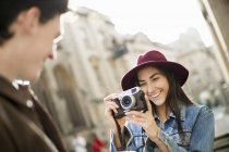 Young woman photographing man — Stock Photo