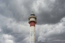 Lighthouse in Huelva in stormy clouds — Stock Photo