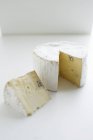 Wheel of cheese on white — Stock Photo