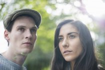 Portrait of young couple, man wearing flat cap — Stock Photo