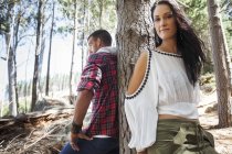 Junges Paar lehnt im Wald an Baum — Stockfoto