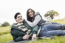 Young couple resting in park — Stock Photo