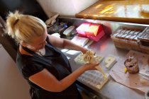 Woman piping praline dough — Stock Photo