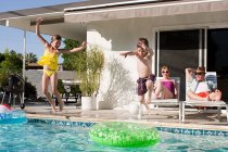 Family and outdoor swimming pool — Stock Photo