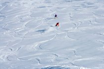 Snowboarders making tracks in snow — Stock Photo