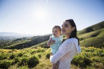 Mother holding young daughter, hiking the Bonneville Shoreline Trail in the Wasatch Foothills above Salt Lake City, Utah — Stock Photo