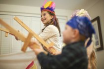 Dressed up boy and sister having sword fight — Stock Photo