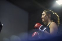 Jovem boxeador feminino tendo luta de boxe no ringue — Fotografia de Stock