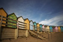 Row of colourful beach huts — Stock Photo