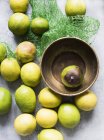 Top view of lemons on table and in bowl with net packaging — Stock Photo