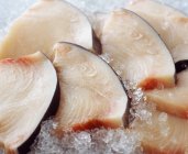 Raw sliced sword fish on crushed ice — Stock Photo