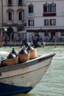 Wine containers on boat, grand canal, venice, italy — Stock Photo