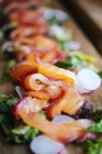 Close up of Gravlax salmon salad on wooden board — Stock Photo