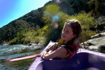 Giovane ragazza che fa kayak su un fiume — Foto stock