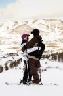 Skiers hugging on mountain top, focus on foreground — Stock Photo