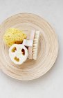 Massage brush loofah and sponge on dish — Stock Photo