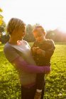 Mother holding son in park — Stock Photo