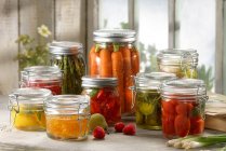 Variety of fruit and vegetables pickled in jars — Stock Photo