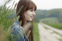 Portrait of young woman next to dirt track — Stock Photo
