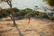Mujer joven haciendo ejercicio al aire libre, corriendo, vista elevada - foto de stock