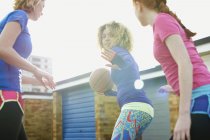 Portrait of three women exercising together playing basketball — Stock Photo