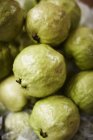 Close up of green fruit for sale at market — Stock Photo