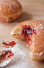 Jam doughnut on table with sugar powder — Stock Photo