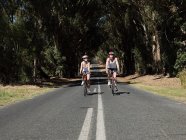 Jeune couple vélo sur la route — Photo de stock
