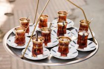Cups of apple tea on hanging tray — Stock Photo