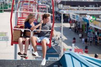 Teenage couple on ferris wheel — Stock Photo