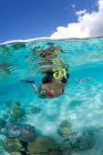 Over/under of snorkeler and ray — Stock Photo