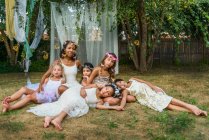 Portrait of mature woman with group of young girls, dressed as fairies, outdoors — Stock Photo