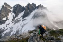Female backpacker on ridge with fog, Picket Pass, North Cascades National Park, WA, USA — Stock Photo