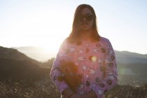 Portrait of man wearing pink pyjamas, holding teddy bear, Malibu Canyon, California, USA — Stock Photo