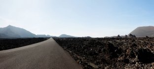 Road through landscape of Montanas del Fuego — Stock Photo