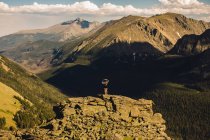 Rear view of woman on rocky outcrop looking away, Rocky Mountain National Park, Colorado, USA — Stock Photo