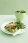 Plate of frittata with salad on table — Stock Photo