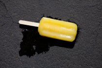 Melting ice lolly on the floor — Stock Photo