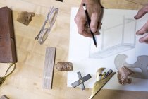 Carpenter at his workshop, close up view of hand drawing — Stock Photo