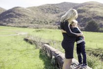 Mother and son hugging outdoors — Stock Photo