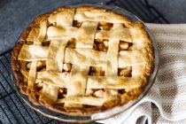 Apple pie with latticed pastry on kitchen counter — Stock Photo