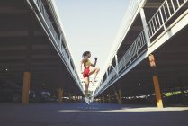 Mujer joven haciendo ejercicio en un entorno urbano - foto de stock