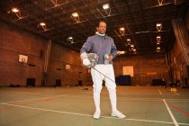 Senior man in fencing suit in hall — Stock Photo