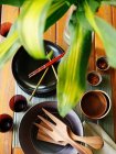 Азиатская столовая посуда через листья растений — стоковое фото